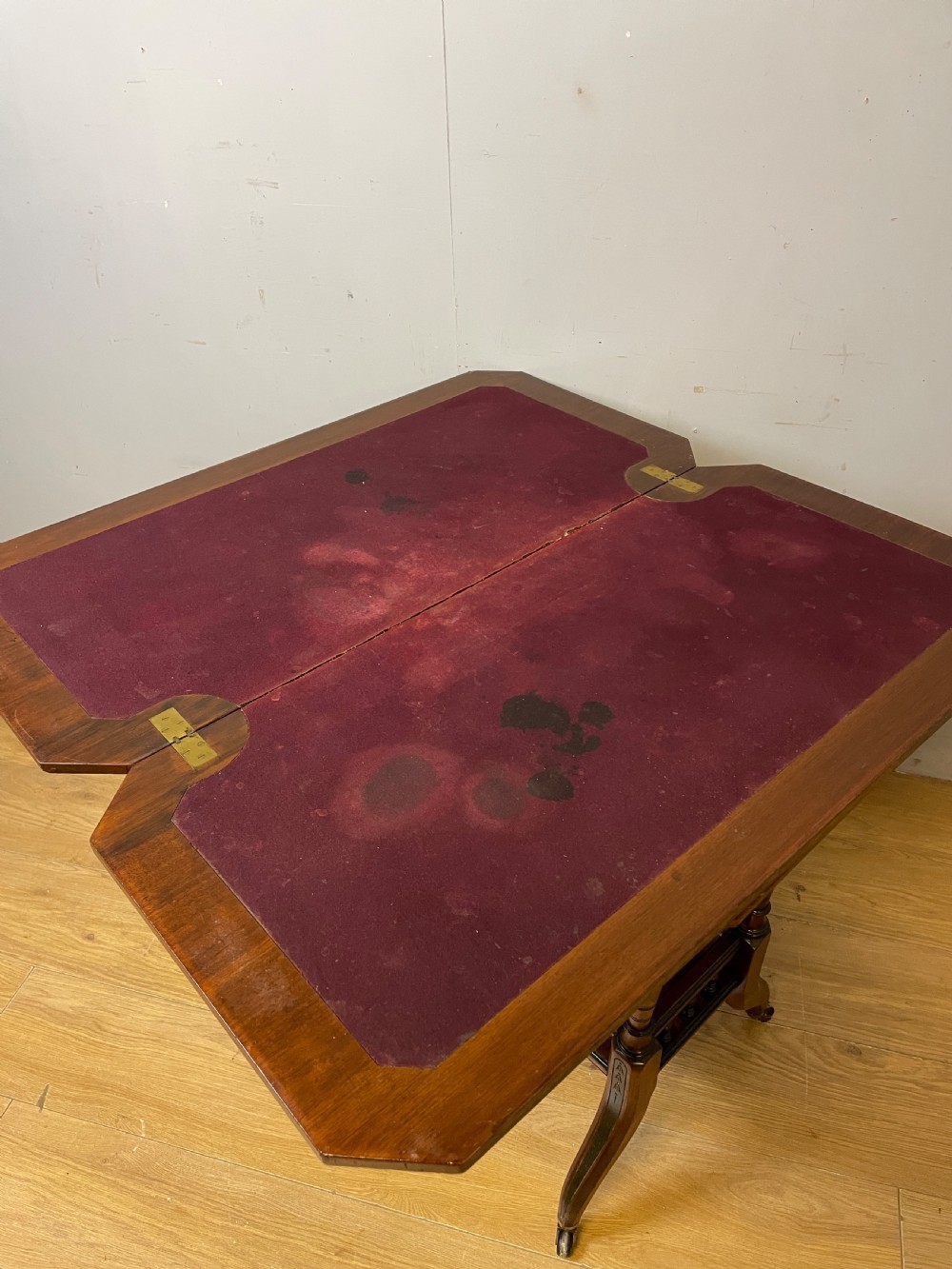 A late 19th-century Aesthetic Movement oak card table with incised top decorations, turned legs, and a lower spindle gallery shelf. View VIII