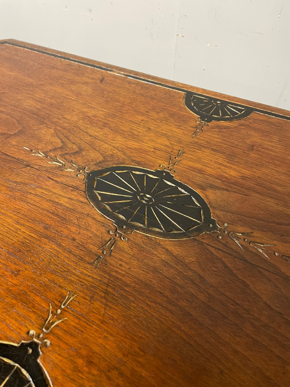 A late 19th-century Aesthetic Movement oak card table with incised top decorations, turned legs, and a lower spindle gallery shelf. View IX