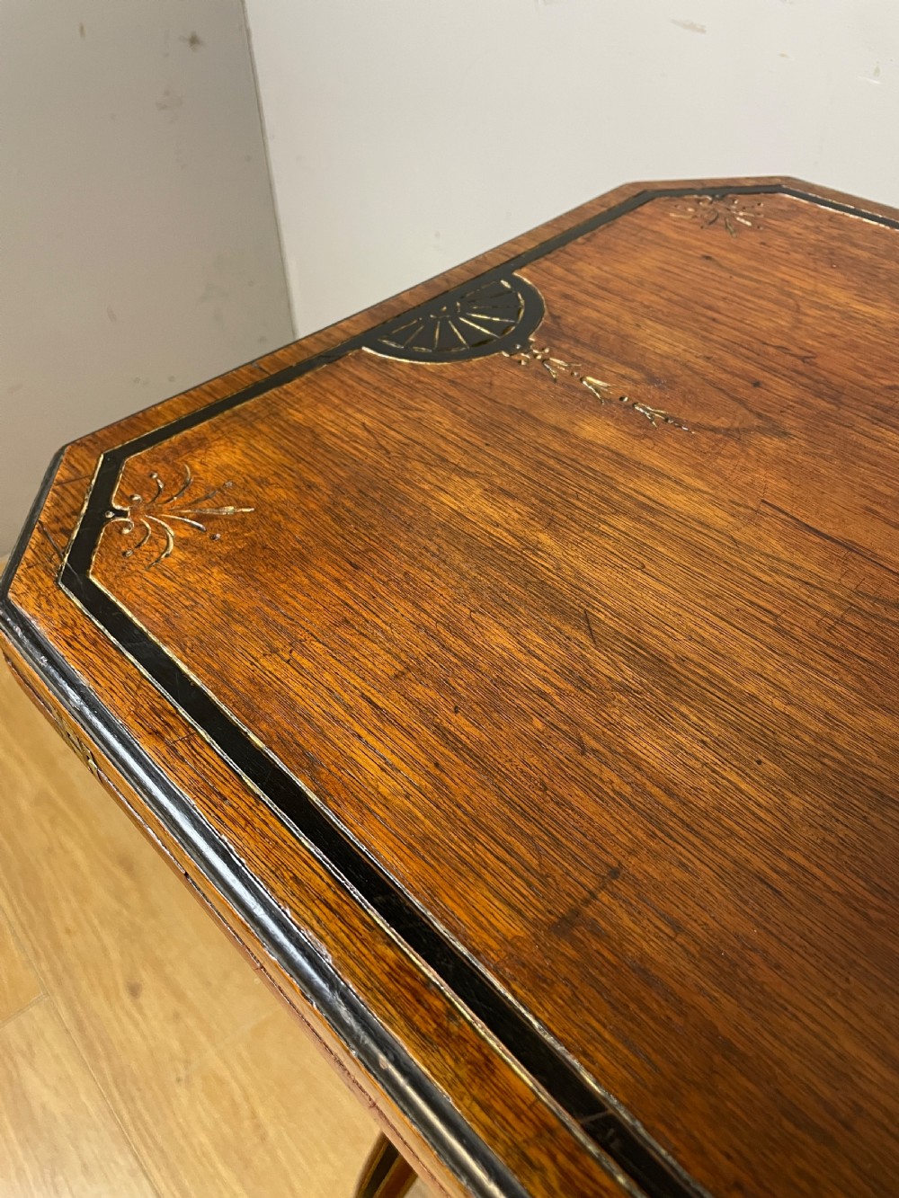 A late 19th-century Aesthetic Movement oak card table with incised top decorations, turned legs, and a lower spindle gallery shelf. View X