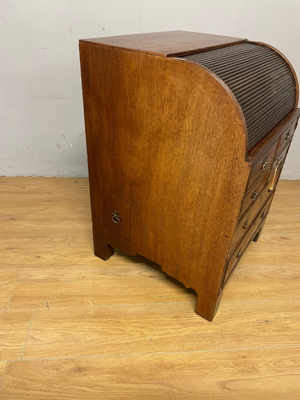 A Georgian mahogany bureau cabinet featuring a curved slatted tambour shutter above four small drawers and two wide drawers with brass handles. View XVI