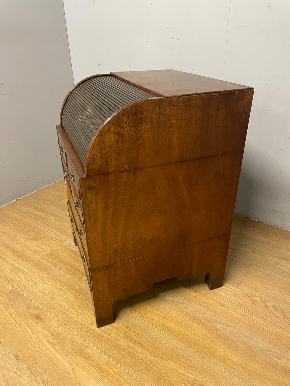 A Georgian mahogany bureau cabinet featuring a curved slatted tambour shutter above four small drawers and two wide drawers with brass handles. View XVIII