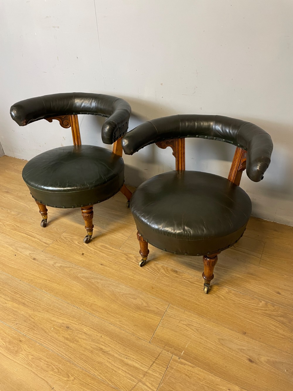 Near pair of C19th century golden oak framed green leather tub chairs 