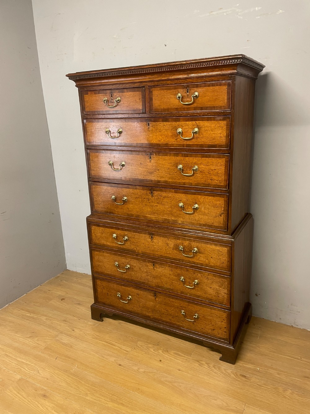 Georgian oak chest on chest with brass swan neck handles and mahogany cross banded drawers  View II