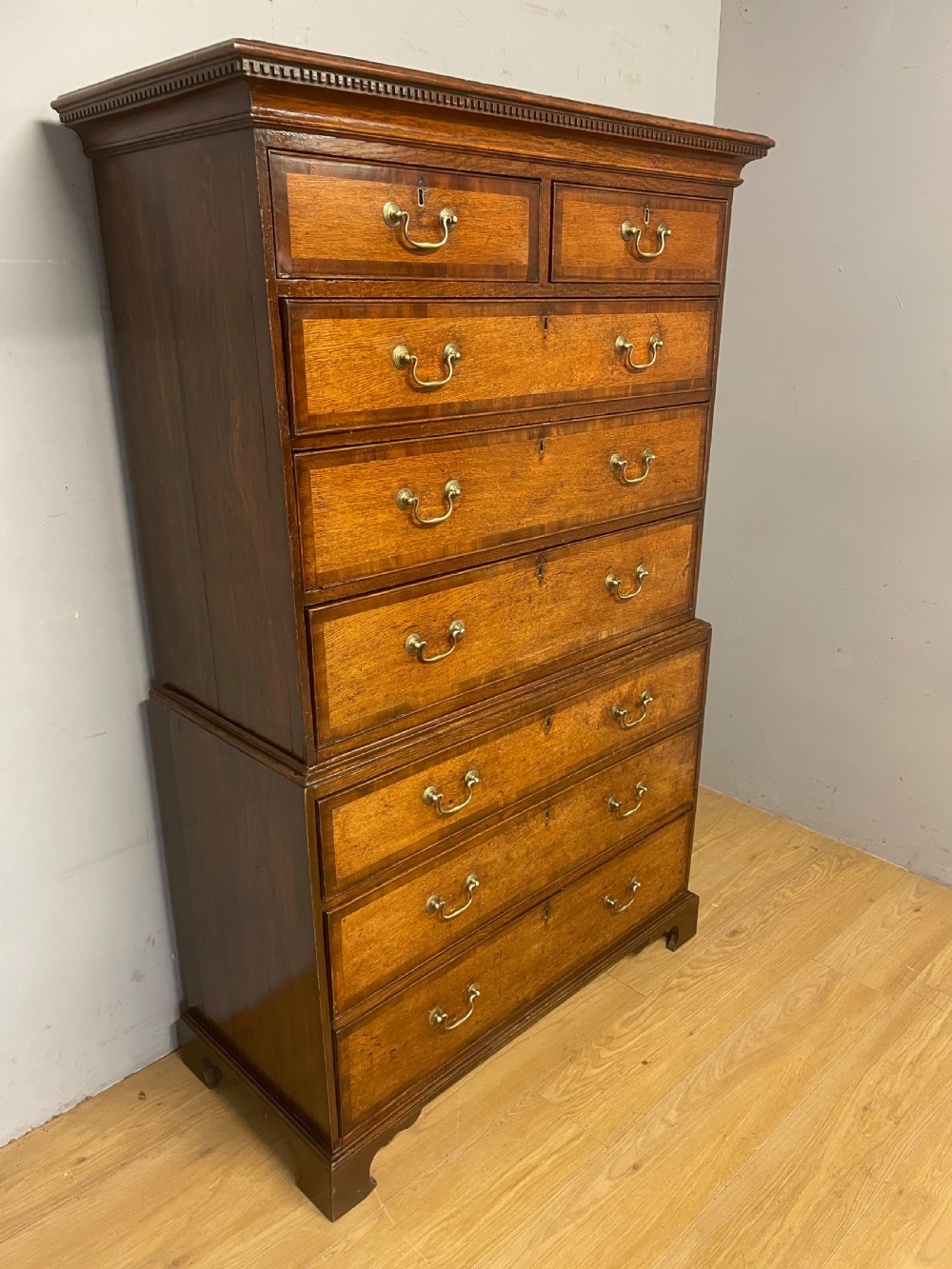 Georgian oak chest on chest with brass swan neck handles and mahogany cross banded drawers  View V