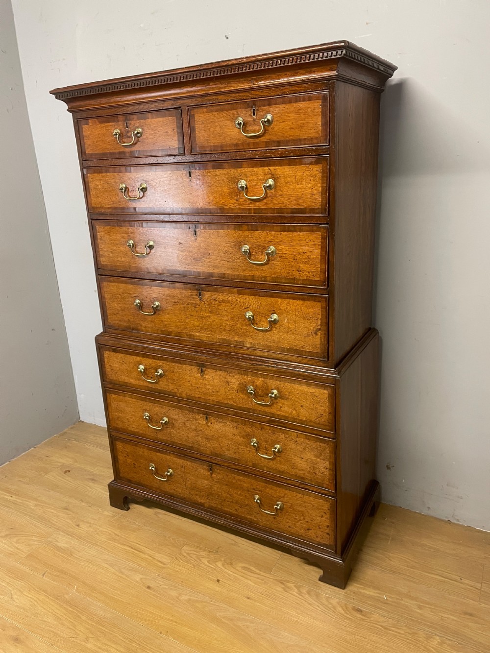 Georgian oak chest on chest with brass swan neck handles and mahogany cross banded drawers  View VIII