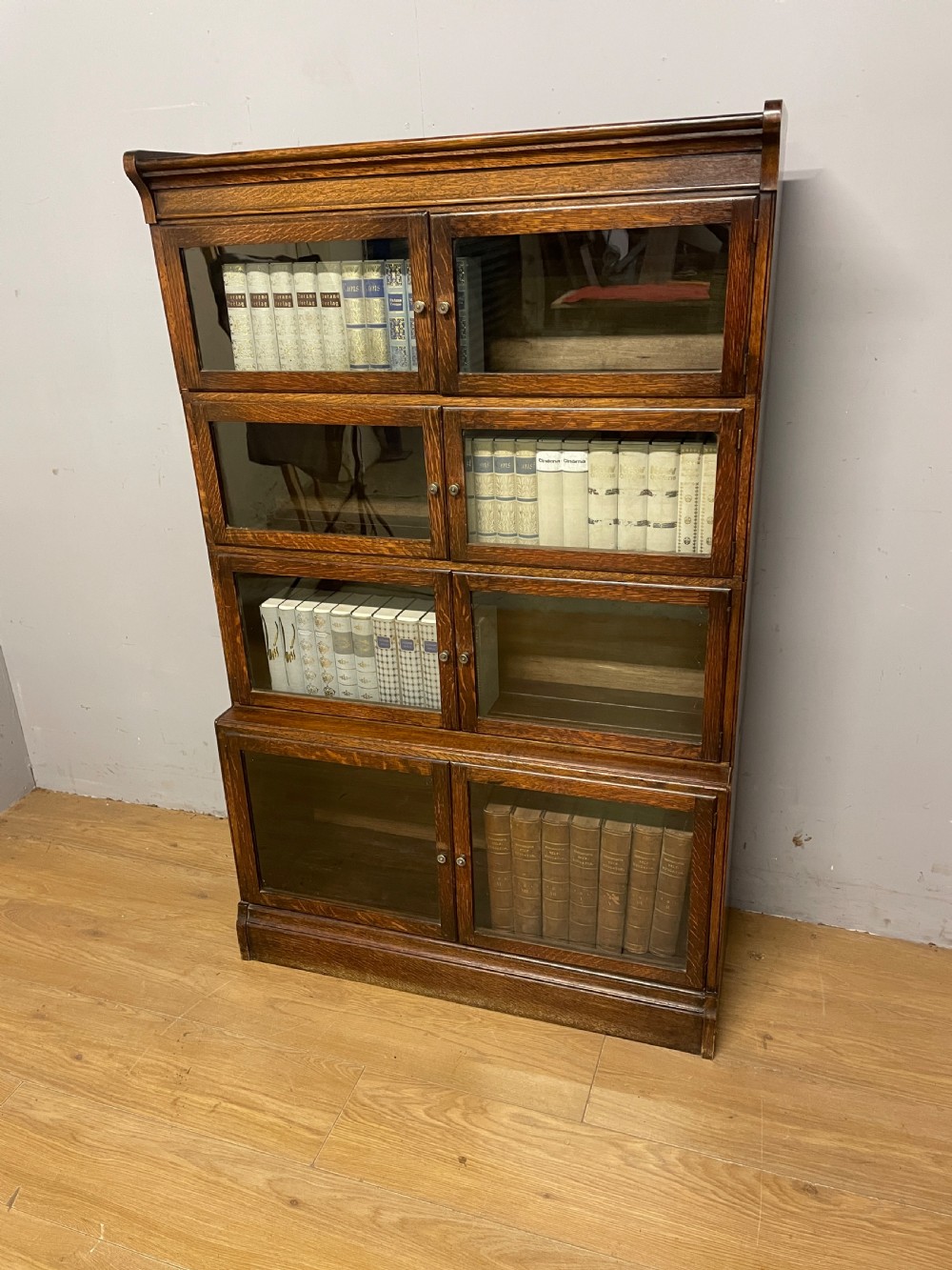 Edwardian oak sectional bookcase with glazed doors (by Minty of Oxford)