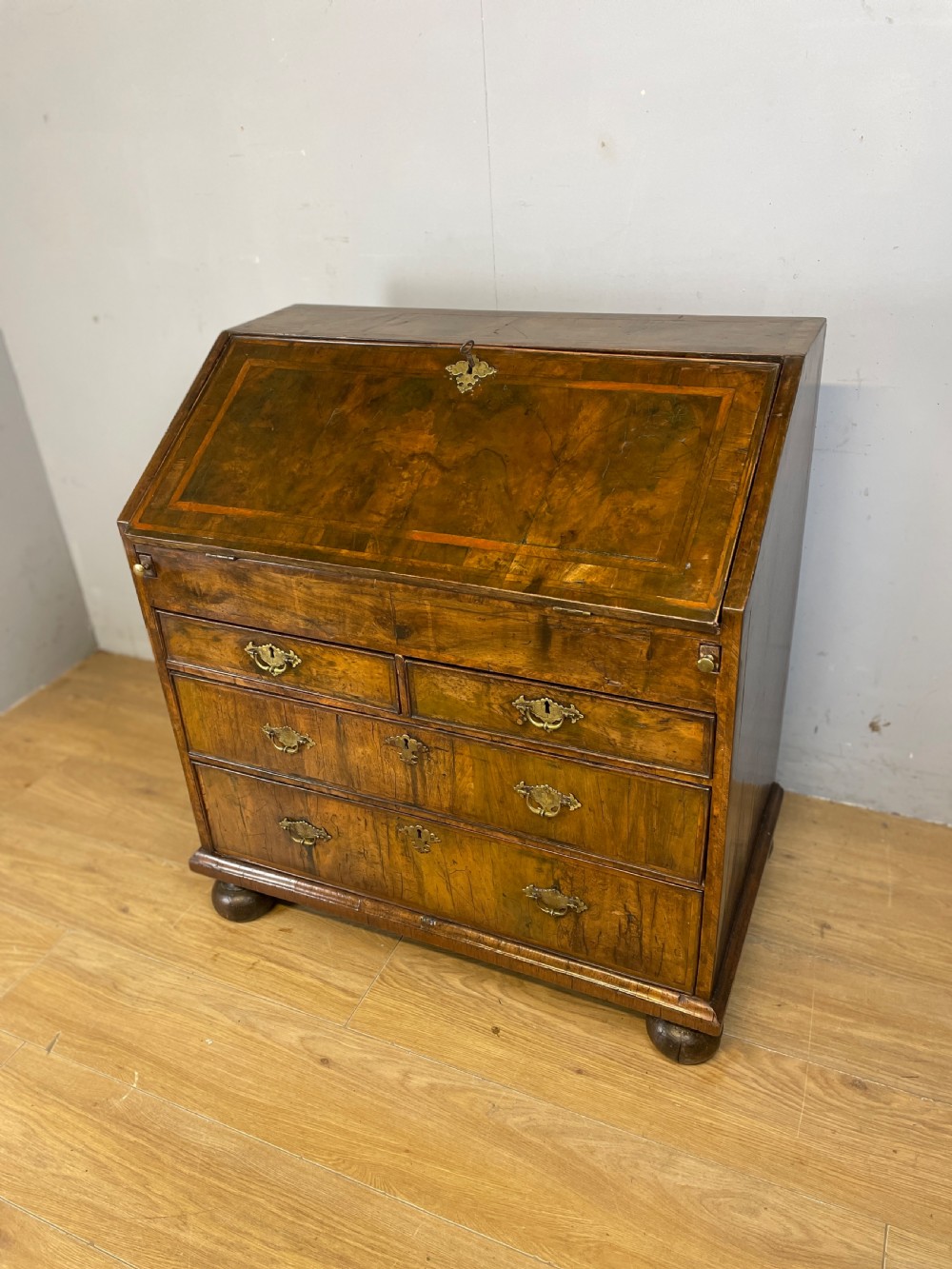 Early eighteenth century walnut bureau on original bun feet 