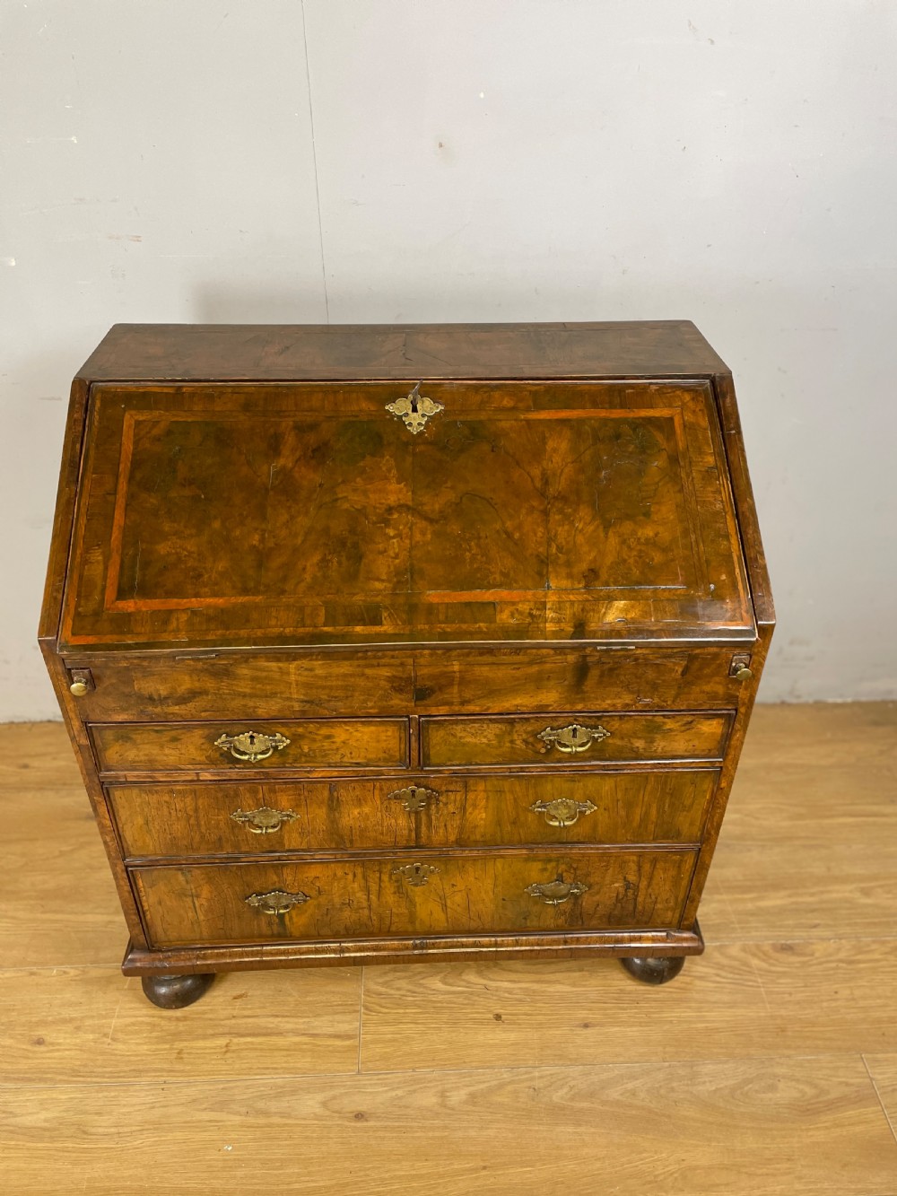 Early eighteenth century walnut bureau on original bun feet  View II