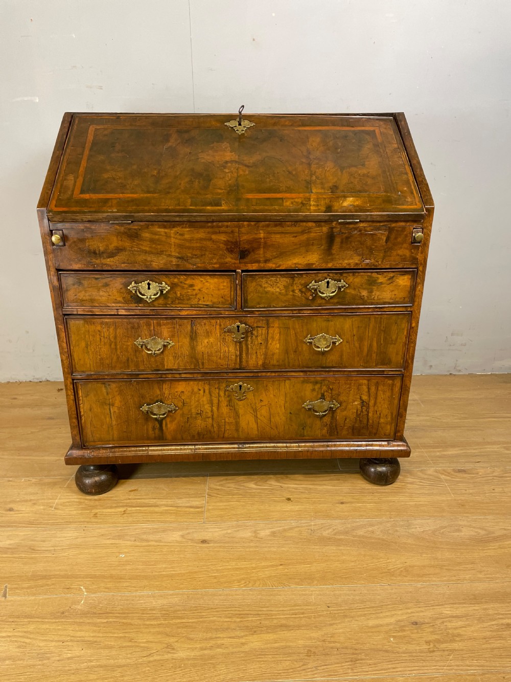 Early eighteenth century walnut bureau on original bun feet  View III