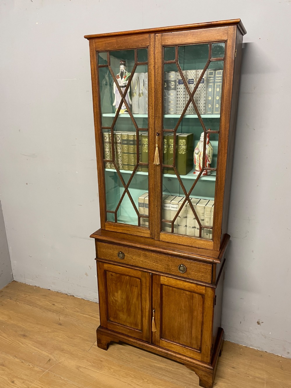 C19th small mahogany bookcase over cupboard only 69 cm wide 