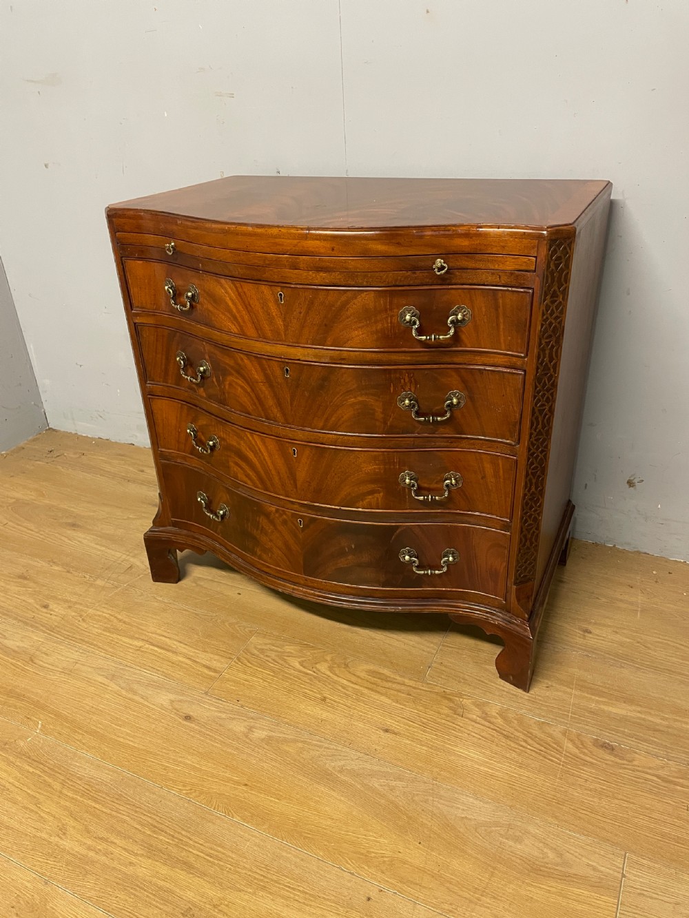 Edwardian small flame mahogany serpentine chest of drawers 