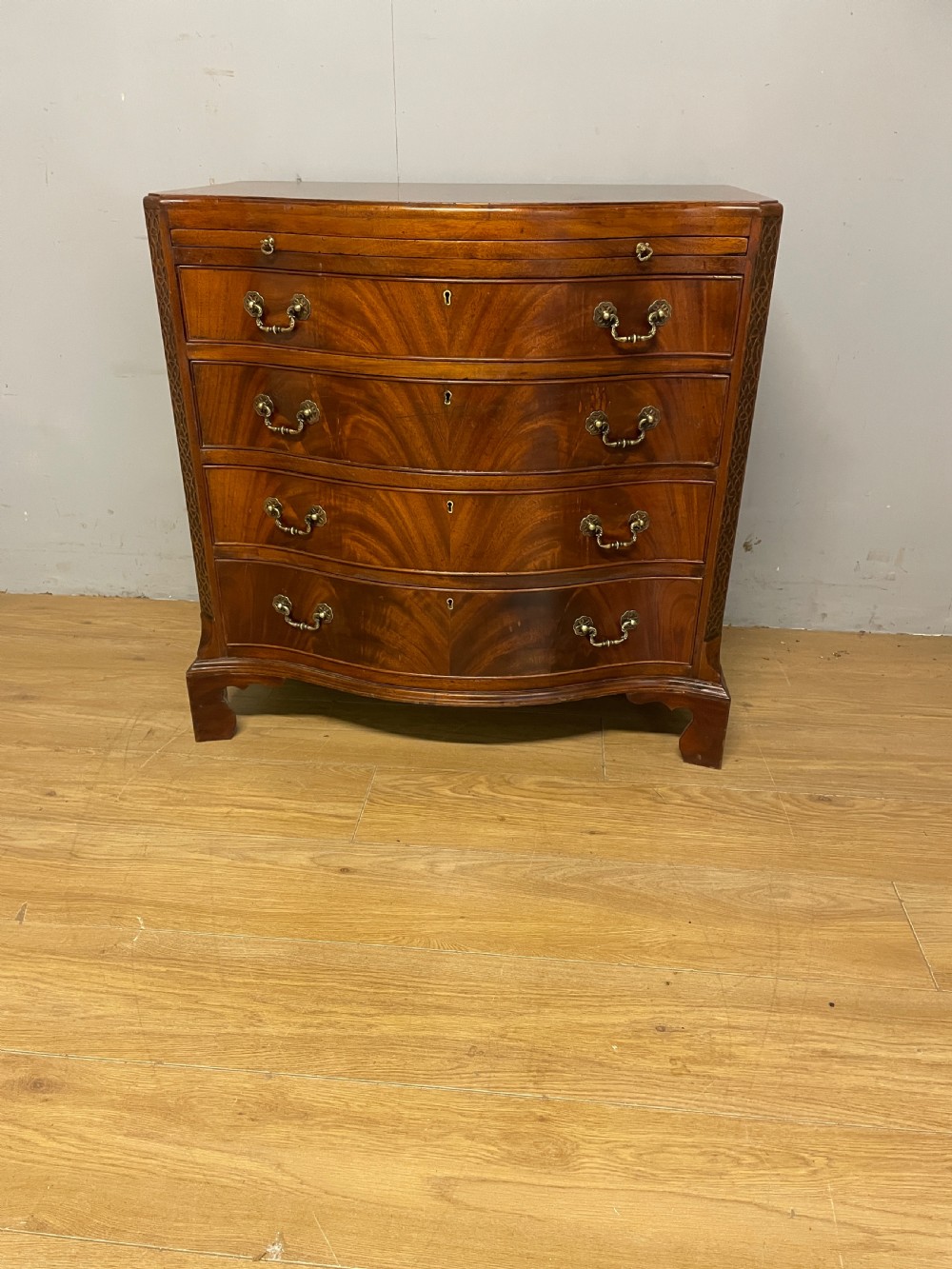 Edwardian small flame mahogany serpentine chest of drawers  View III
