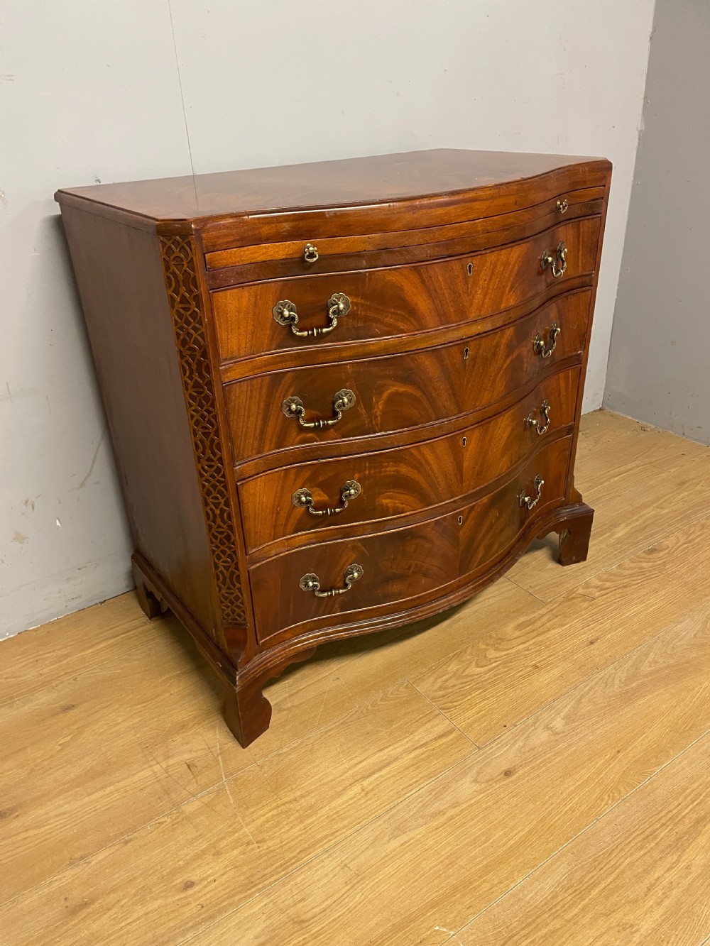 Edwardian small flame mahogany serpentine chest of drawers  View IV