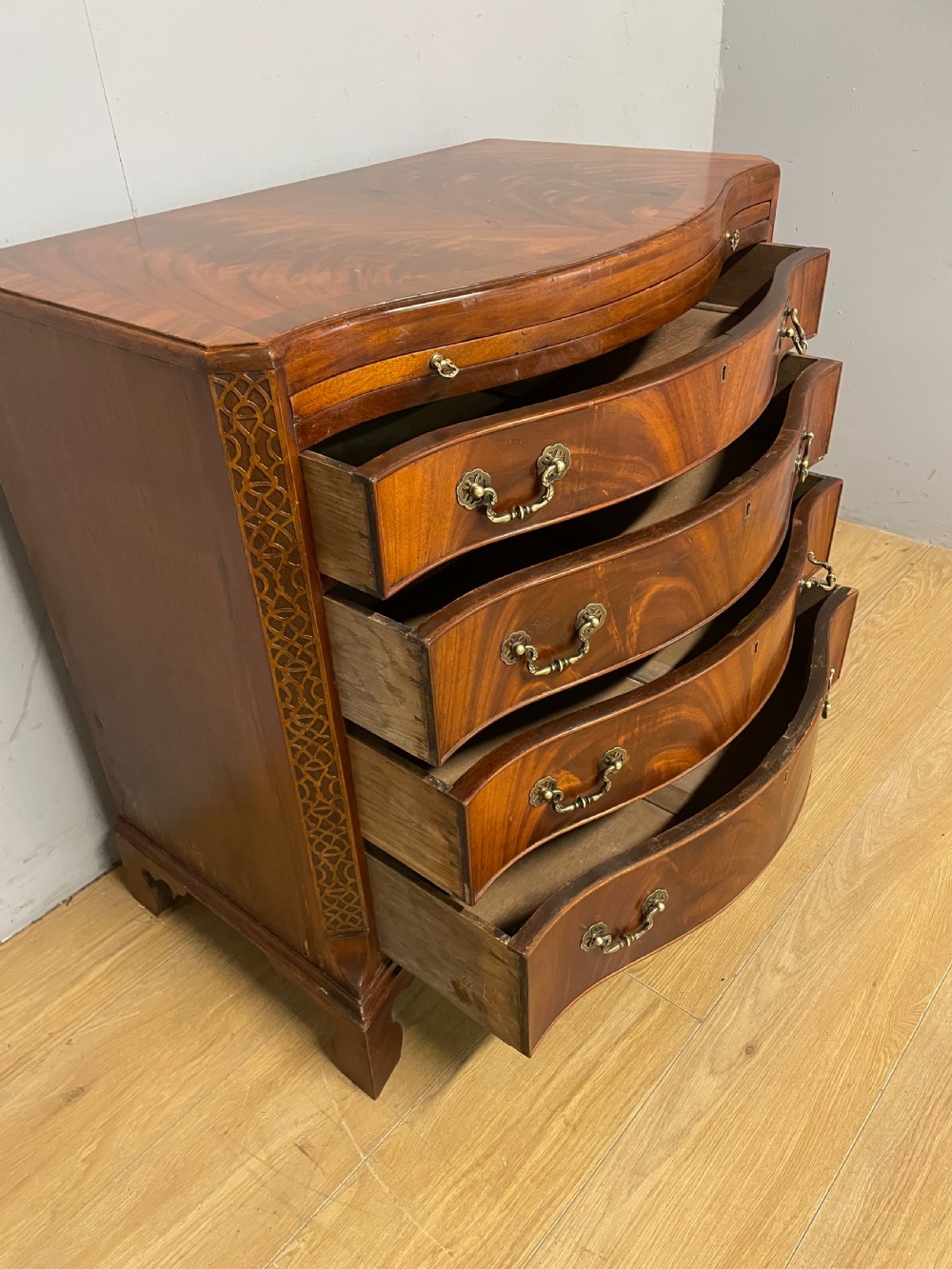 Edwardian small flame mahogany serpentine chest of drawers  View VII