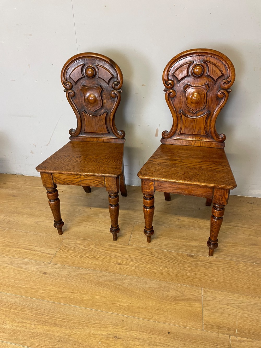 Pair of carved oak nineteenth century hall chairs 