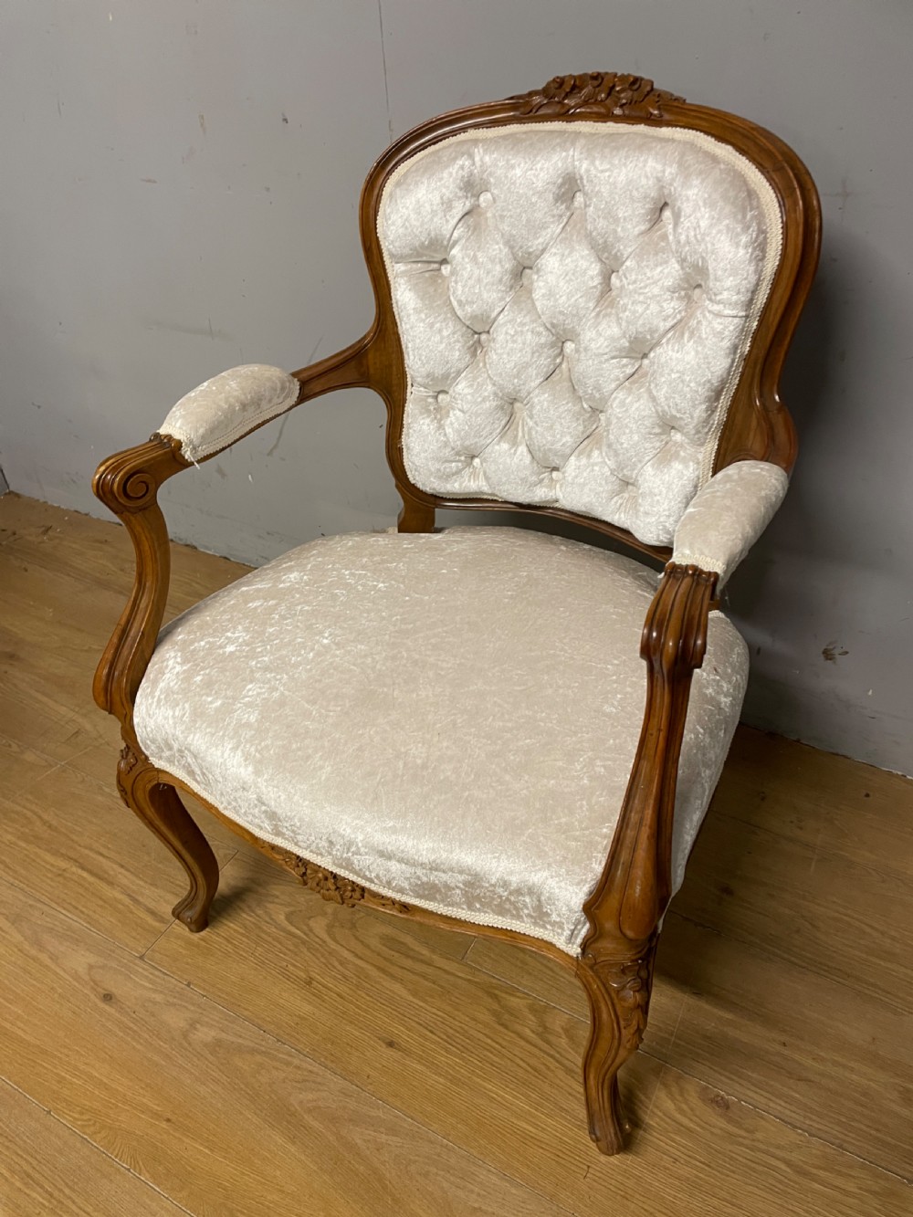 A carved walnut armchair featuring a deep button-tufted cream velvet backrest, padded armrests, and curved cabriole legs. View II