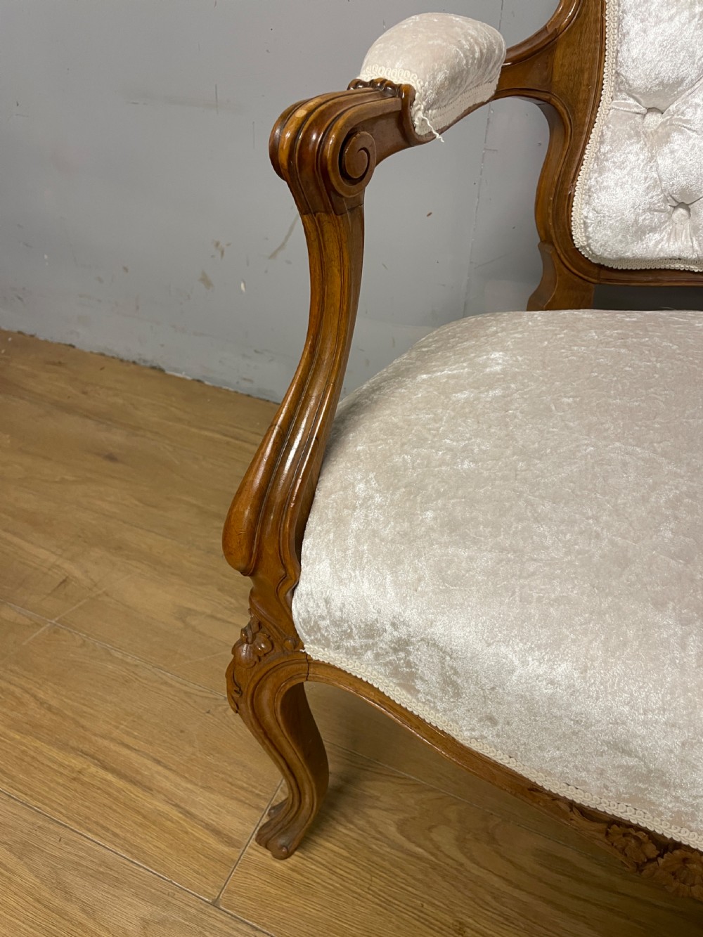 A carved walnut armchair featuring a deep button-tufted cream velvet backrest, padded armrests, and curved cabriole legs. View IV