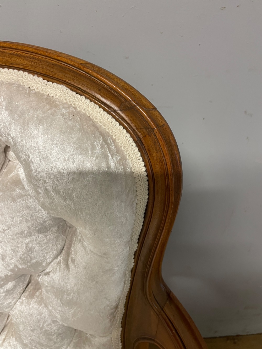 A carved walnut armchair featuring a deep button-tufted cream velvet backrest, padded armrests, and curved cabriole legs. View VI