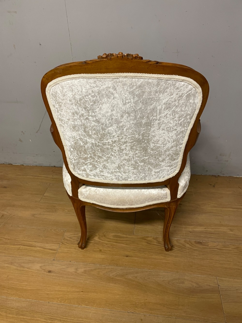 A carved walnut armchair featuring a deep button-tufted cream velvet backrest, padded armrests, and curved cabriole legs. View VIII