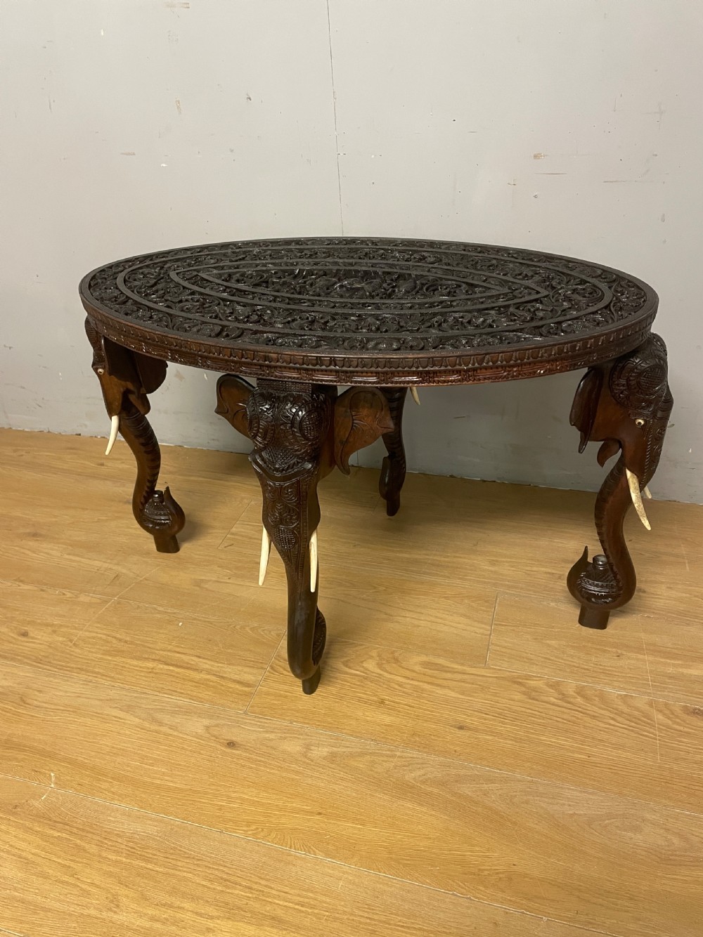 C19TH carved Indian oval table with stylised elephant legs 