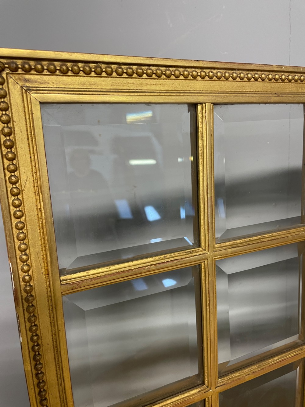 A nineteenth-century three-panel giltwood folding screen featuring glazed upper window panes and golden damask upholstered lower sections. View III