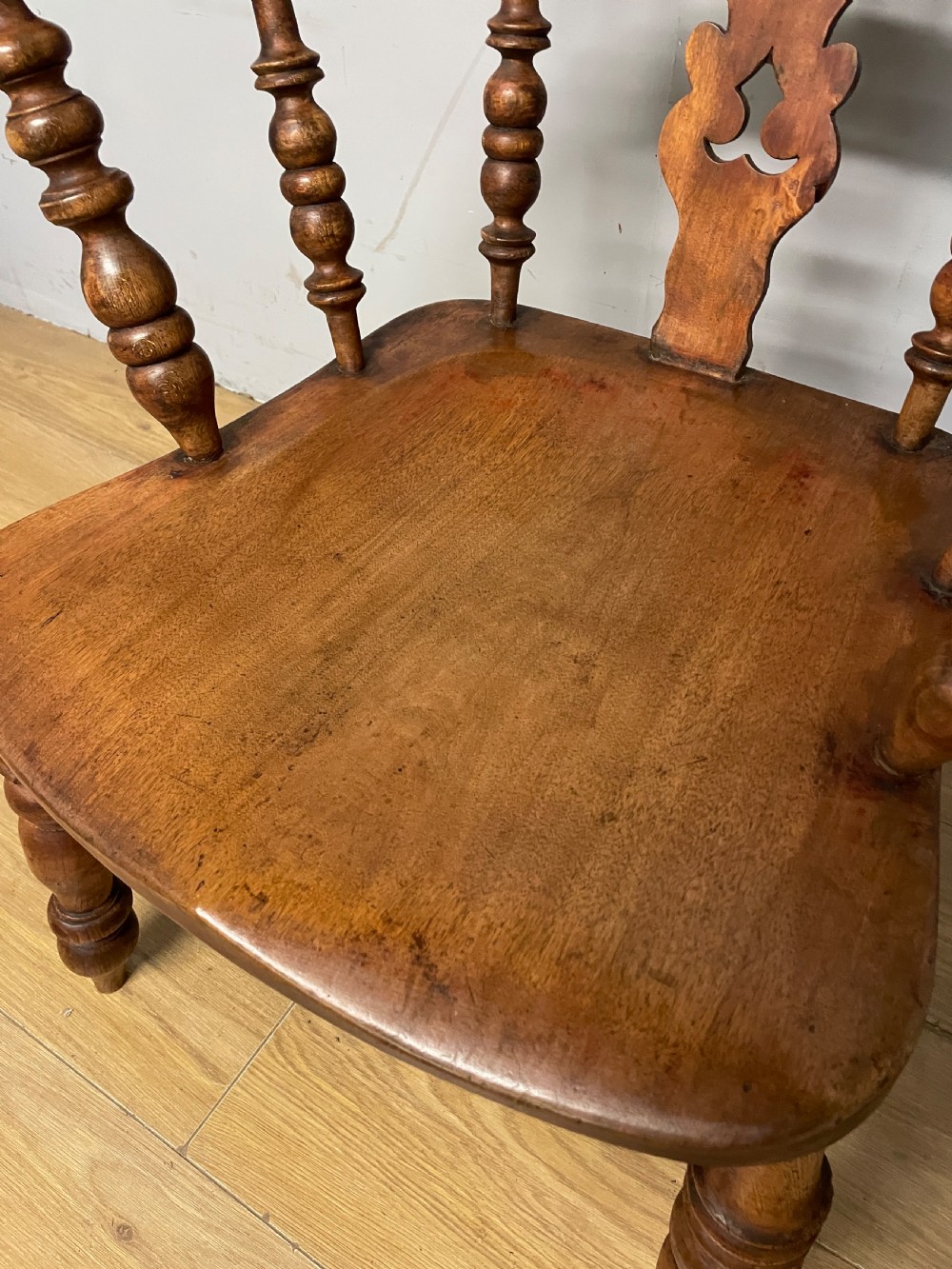 A 19th-century ash and elm Windsor armchair featuring a hoop back, pierced central splat, turned arm supports, and a solid contoured seat. View IX