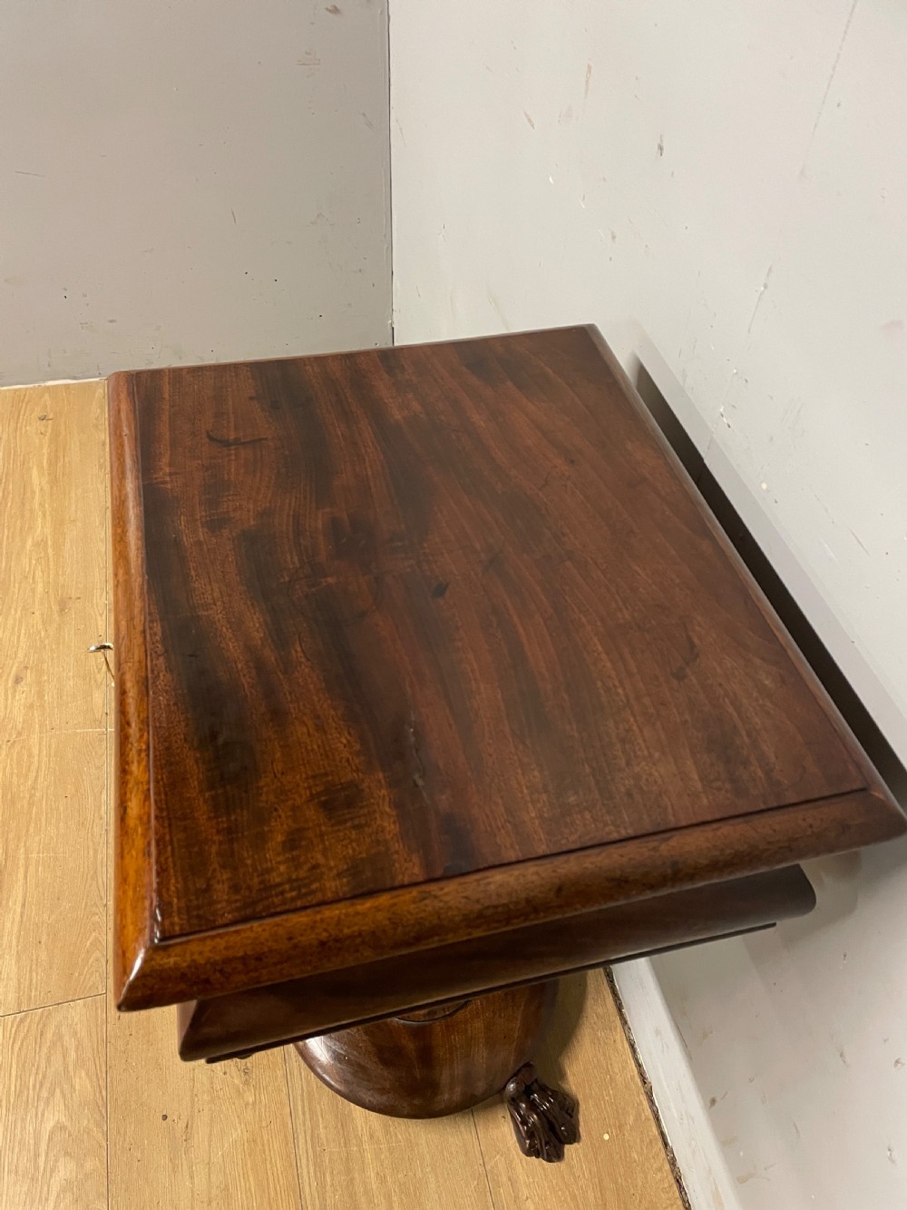 A Regency flame mahogany work table featuring a curved apron, central turned pedestal, circular plinth, and carved lion paw feet. View VIII