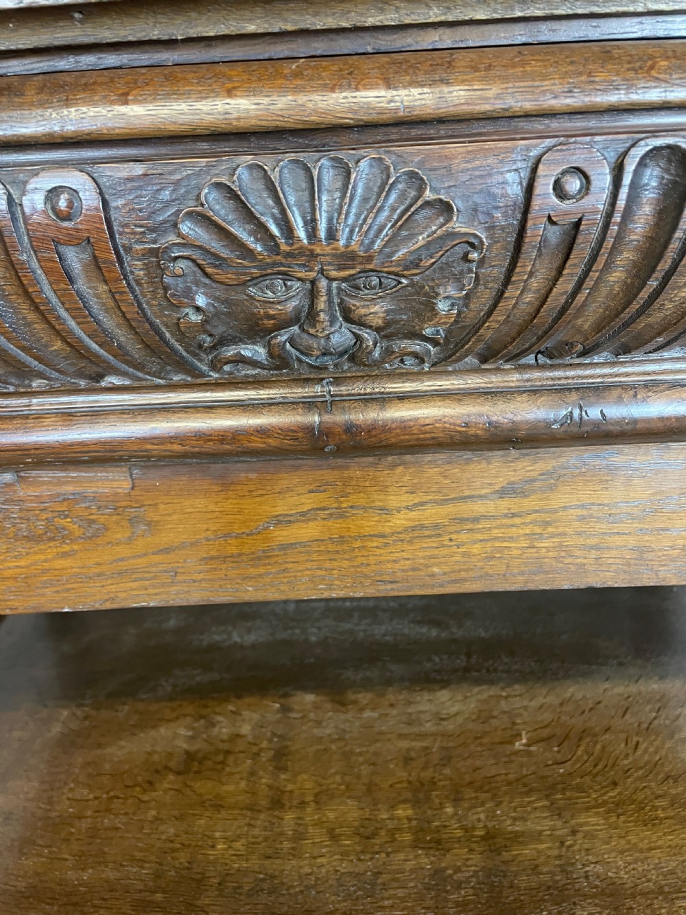 A 19th-century dark carved oak two-tier side table featuring turned legs and a detailed carved frieze. View XII