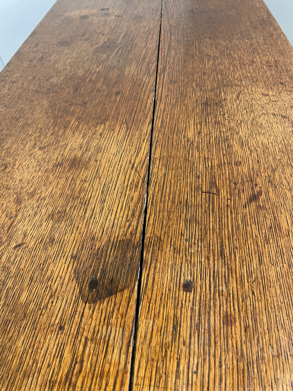 A large 19th-century dark oak drop-leaf dining table featuring turned gatelegs and a carved egg-and-dart motif along the oval table top border. View XI