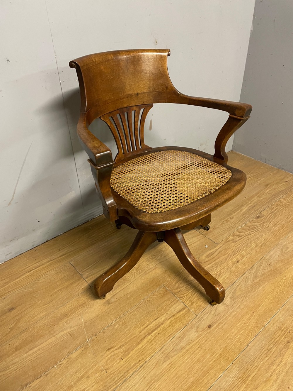 Edwardian swivel tilting office chair with a cane seat 