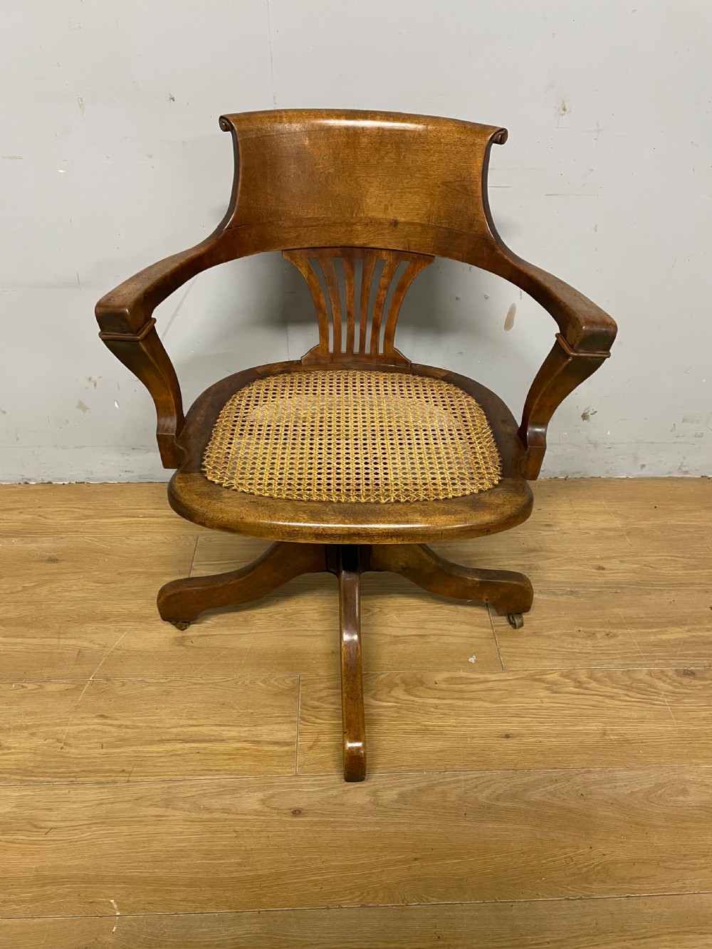 Edwardian swivel tilting office chair with a cane seat  View II