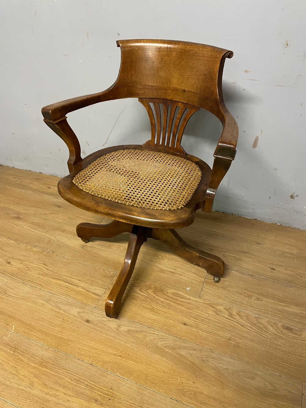 Edwardian swivel tilting office chair with a cane seat  View IV
