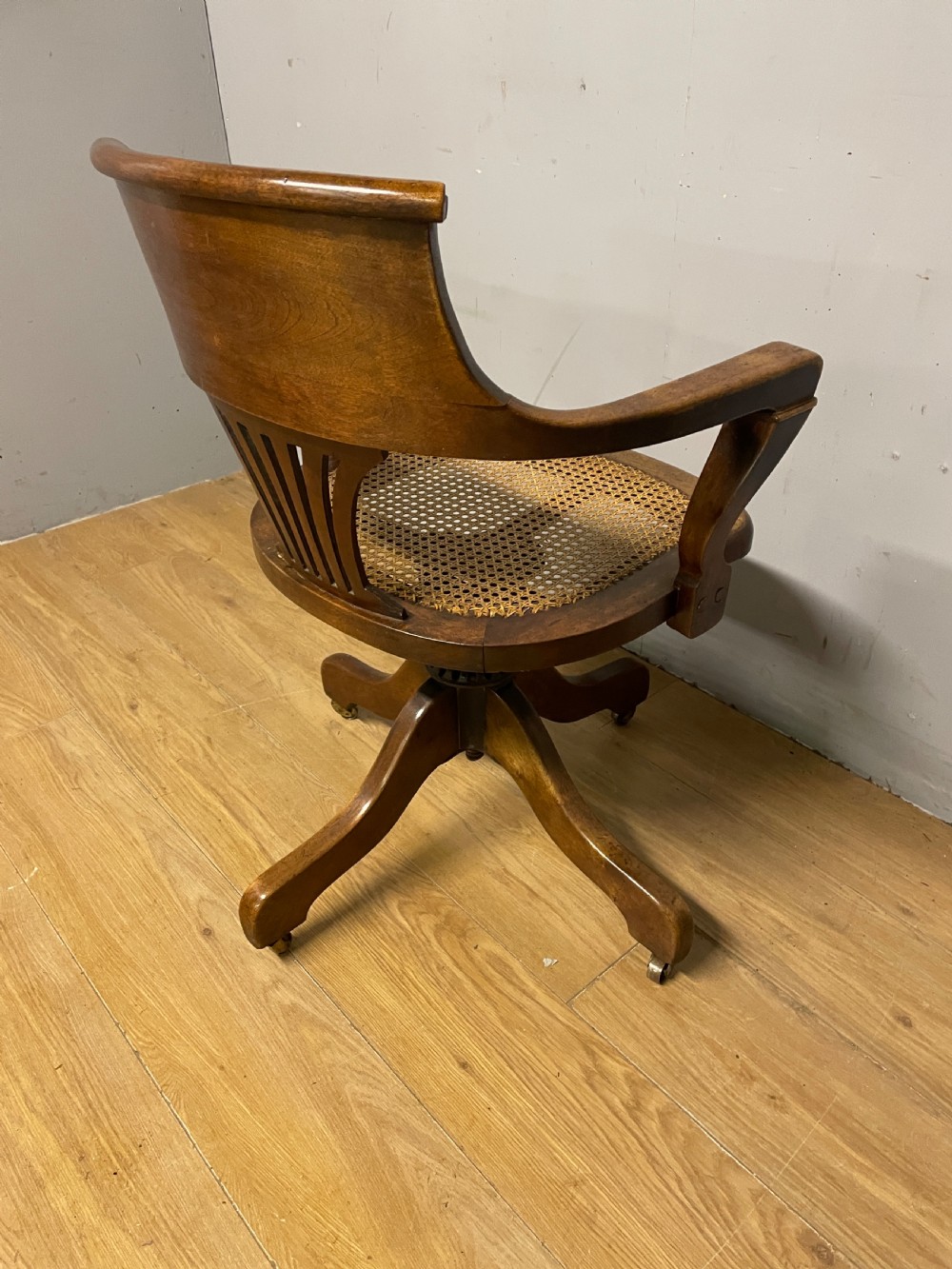 Edwardian swivel tilting office chair with a cane seat  View IX