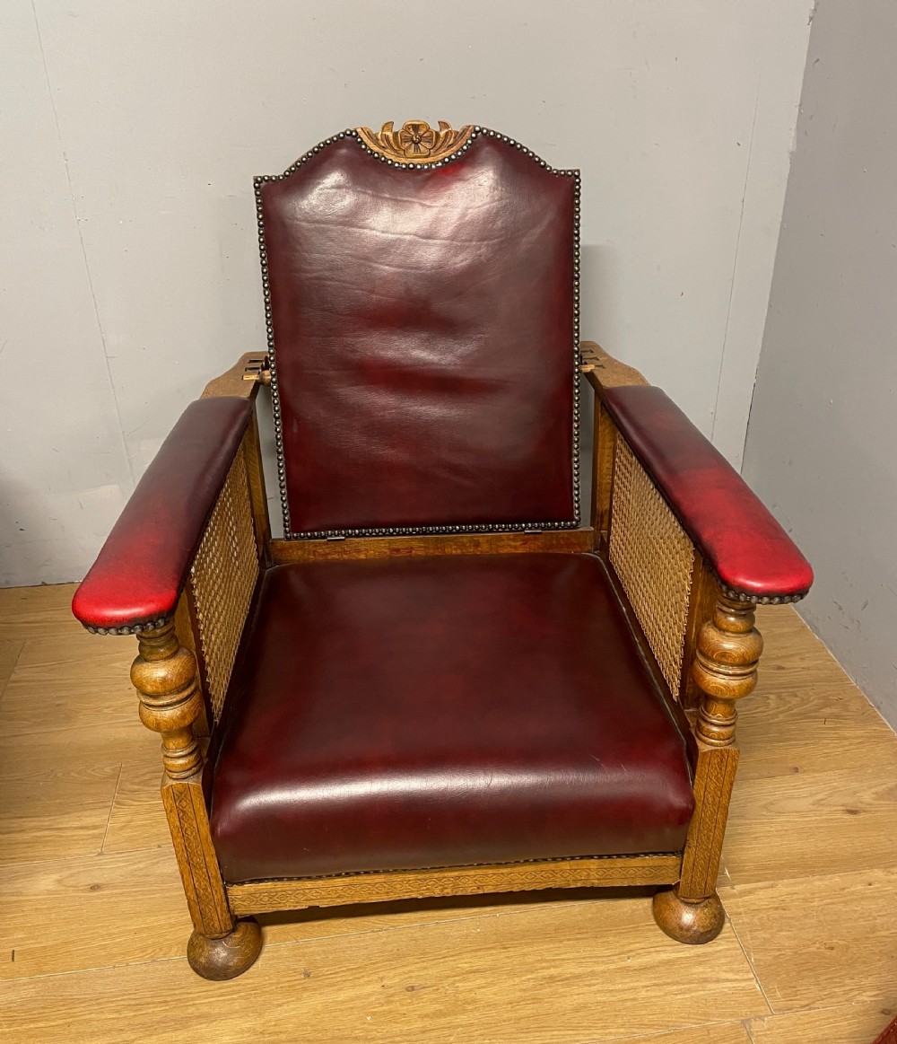 Pair of Arts and Crafts golden oak reclining leather library chairs  View V