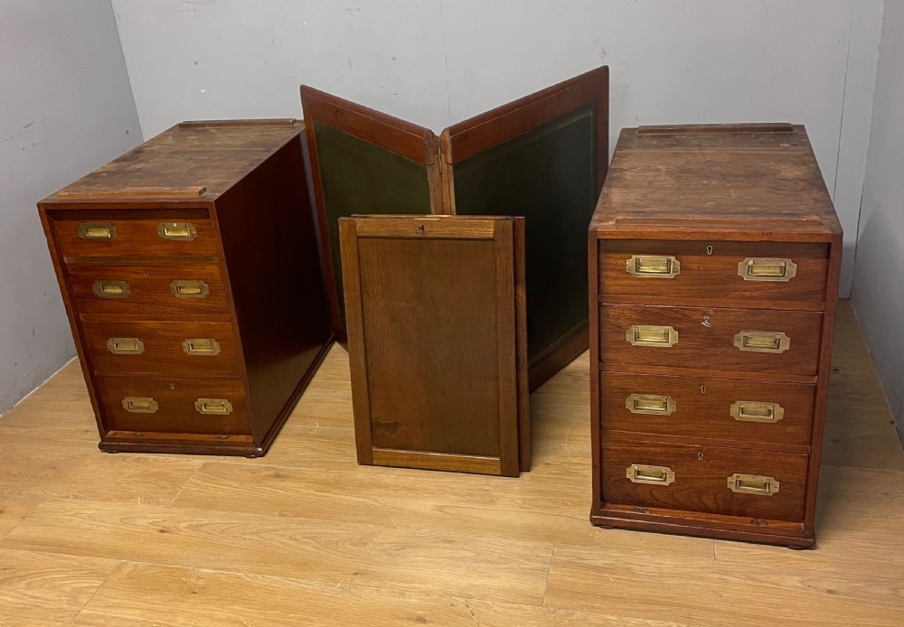 A 19th-century teak three-part military campaign desk featuring a green leather inset writing surface and flush brass drawer handles. View II