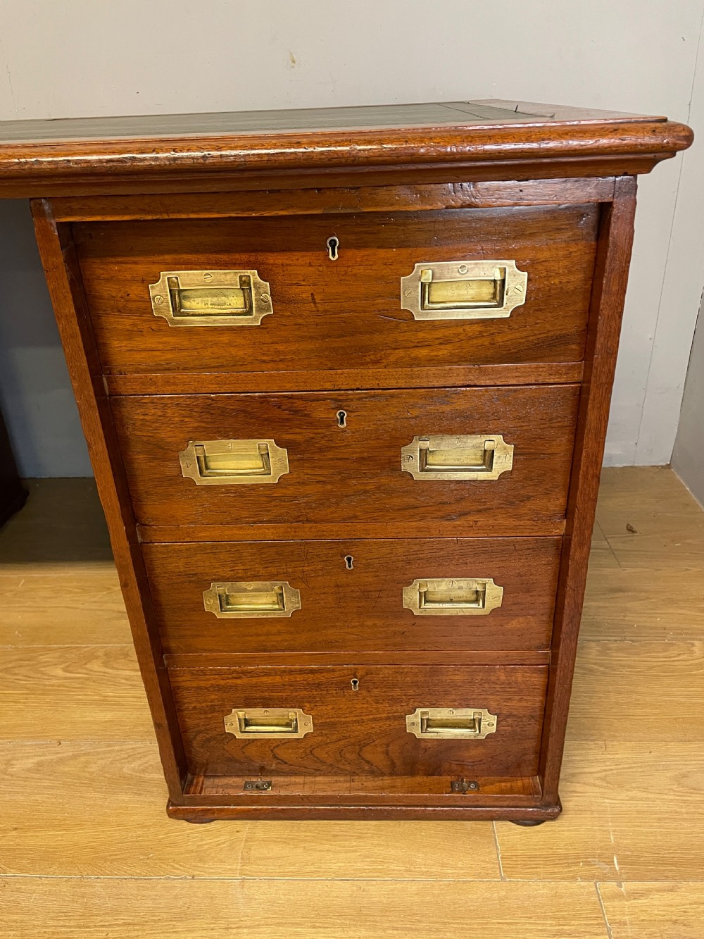 A 19th-century teak three-part military campaign desk featuring a green leather inset writing surface and flush brass drawer handles. View III