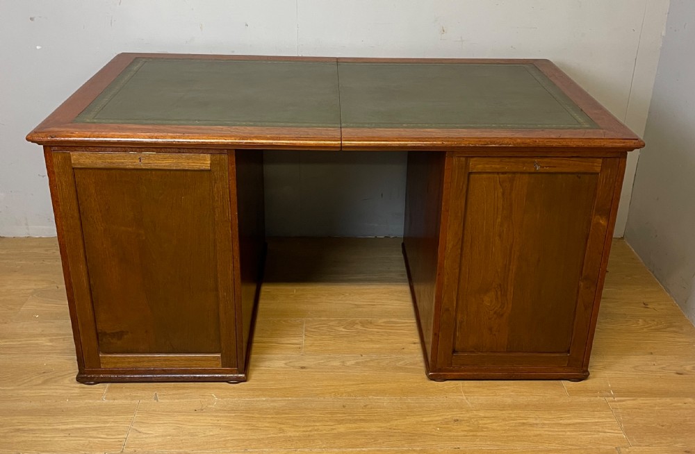 A 19th-century teak three-part military campaign desk featuring a green leather inset writing surface and flush brass drawer handles. View VII