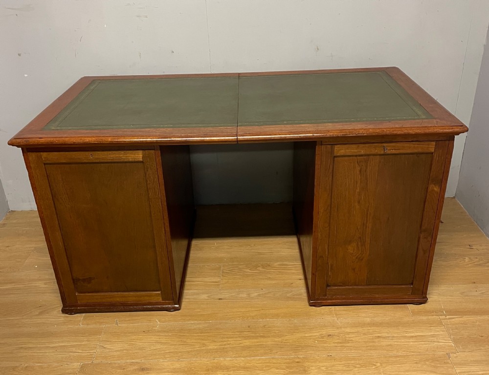 A 19th-century teak three-part military campaign desk featuring a green leather inset writing surface and flush brass drawer handles. View VIII