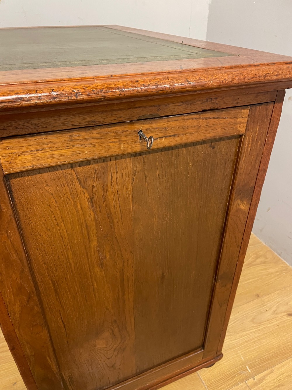 A 19th-century teak three-part military campaign desk featuring a green leather inset writing surface and flush brass drawer handles. View IX