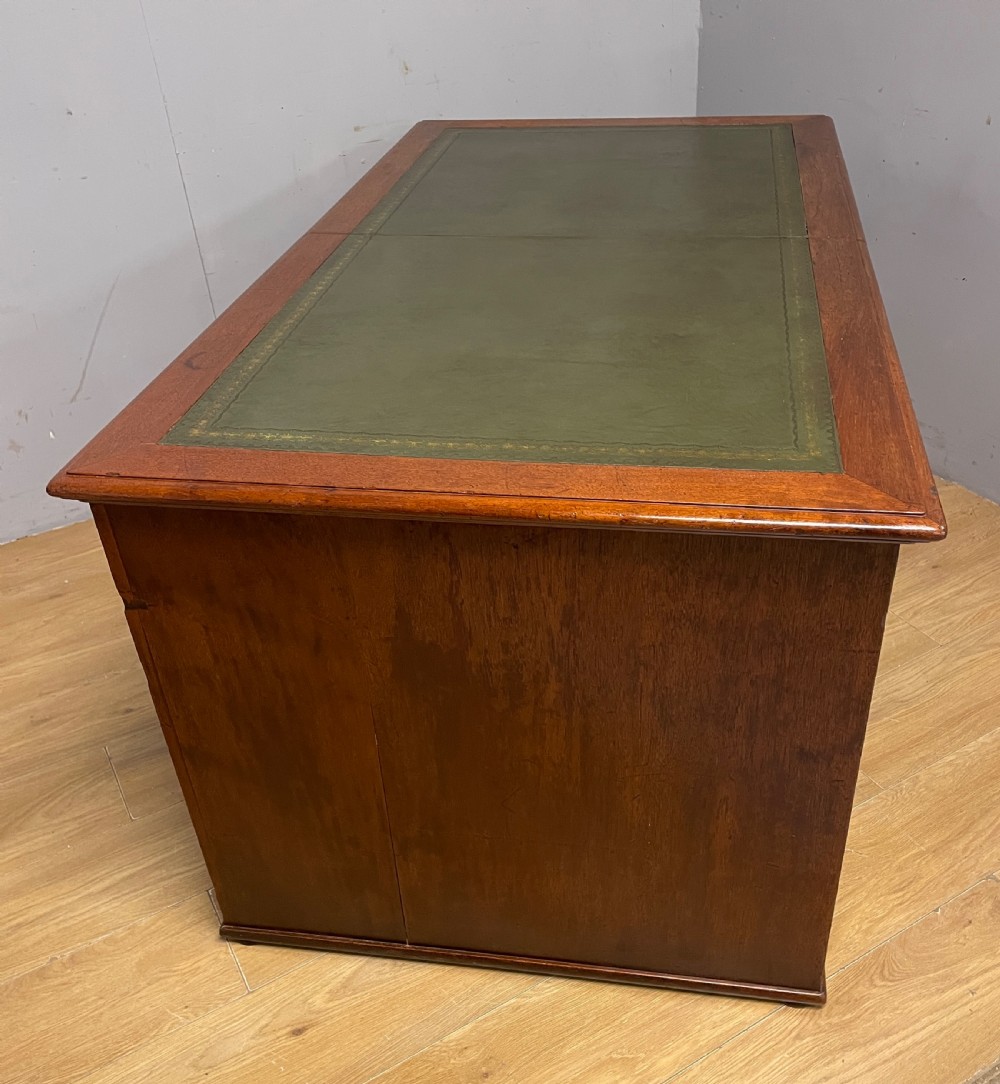 A 19th-century teak three-part military campaign desk featuring a green leather inset writing surface and flush brass drawer handles. View XIII