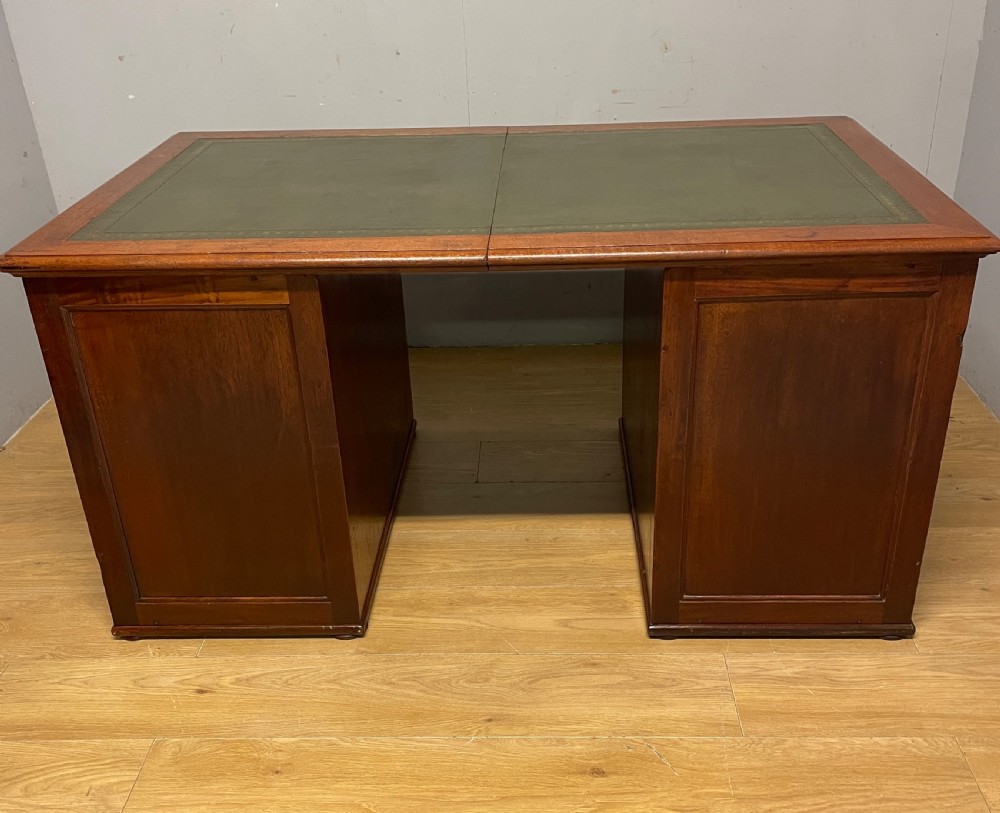 A 19th-century teak three-part military campaign desk featuring a green leather inset writing surface and flush brass drawer handles. View XIV