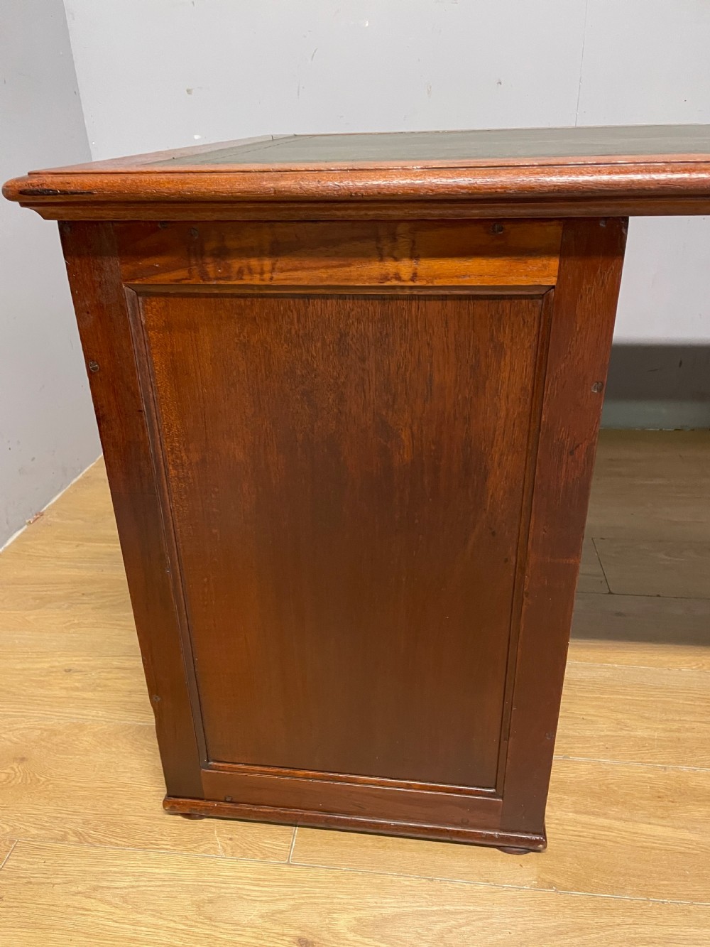 A 19th-century teak three-part military campaign desk featuring a green leather inset writing surface and flush brass drawer handles. View XV