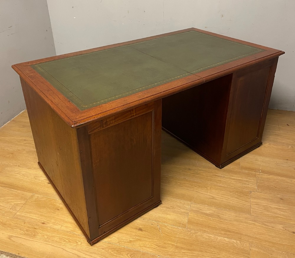 A 19th-century teak three-part military campaign desk featuring a green leather inset writing surface and flush brass drawer handles. View XVII