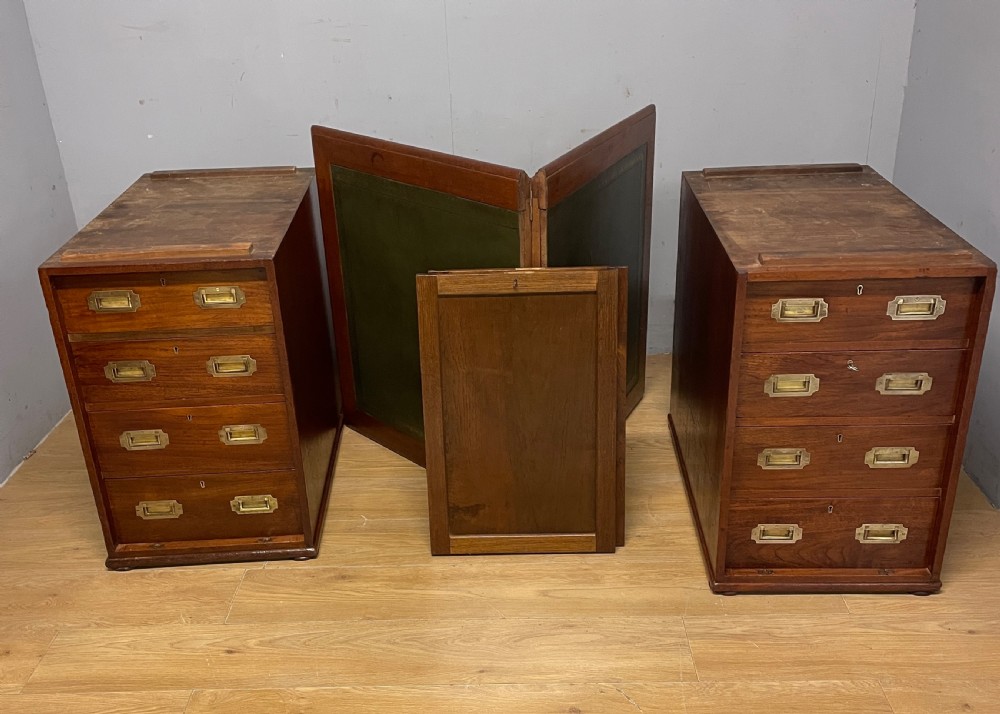 A 19th-century teak three-part military campaign desk featuring a green leather inset writing surface and flush brass drawer handles. View XVIII