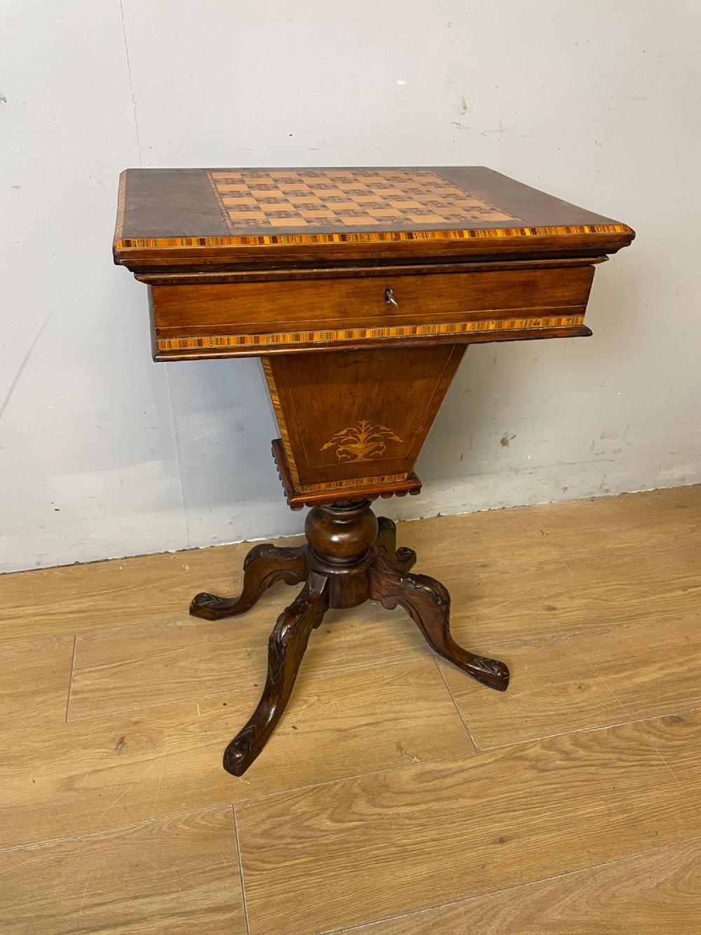 A 19th-century Victorian walnut sewing and games table featuring an inlaid chessboard top, a tapered central storage well, and a carved pedestal base. View II