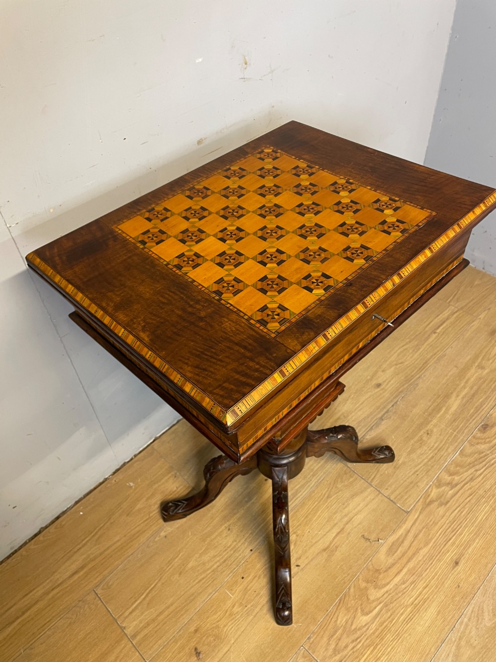 A 19th-century Victorian walnut sewing and games table featuring an inlaid chessboard top, a tapered central storage well, and a carved pedestal base. View III