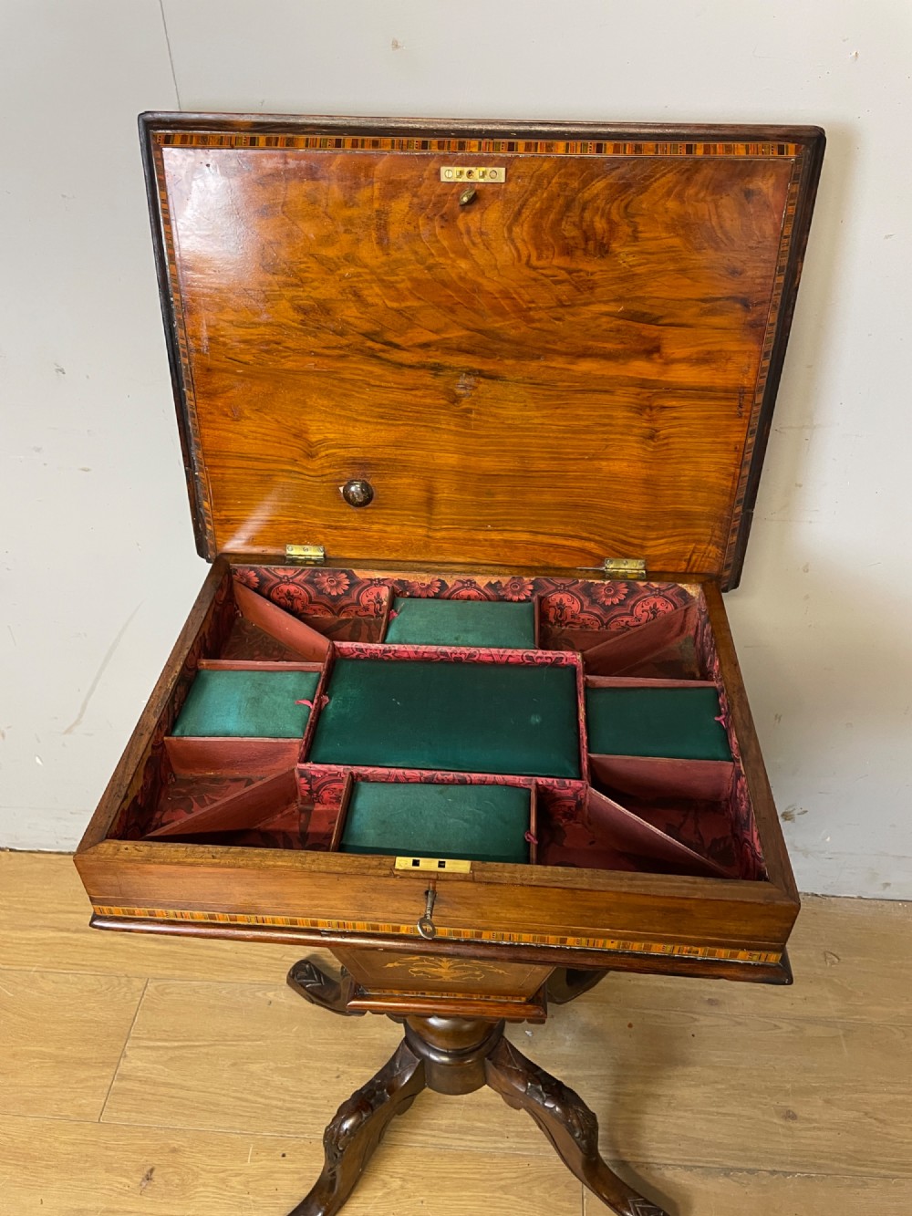 A 19th-century Victorian walnut sewing and games table featuring an inlaid chessboard top, a tapered central storage well, and a carved pedestal base. View VI
