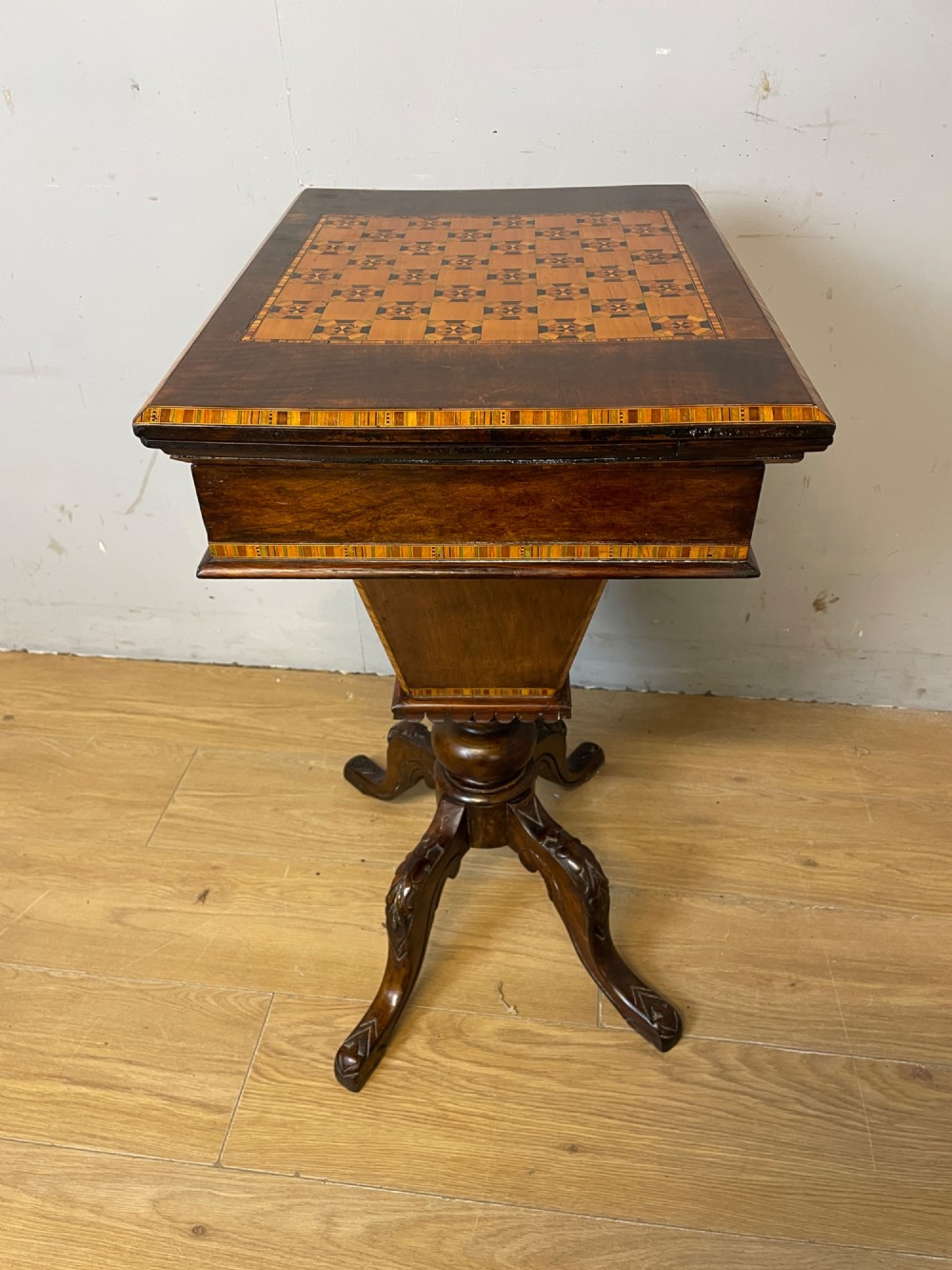 A 19th-century Victorian walnut sewing and games table featuring an inlaid chessboard top, a tapered central storage well, and a carved pedestal base. View XII