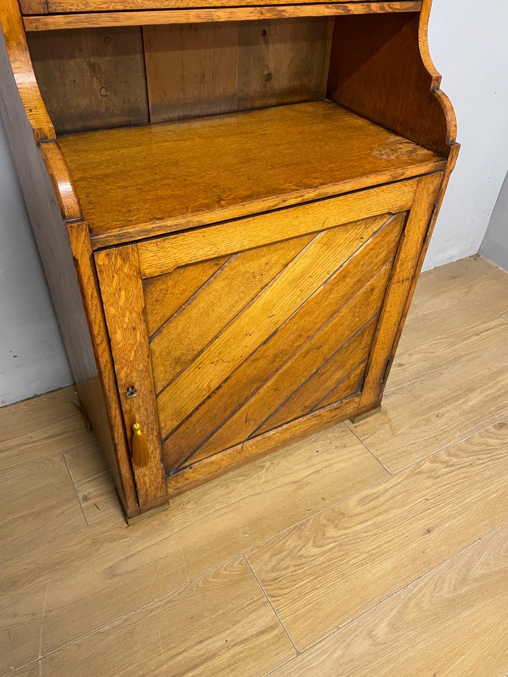 Arts and Crafts golden oak slim bookcase over cupboard View IV