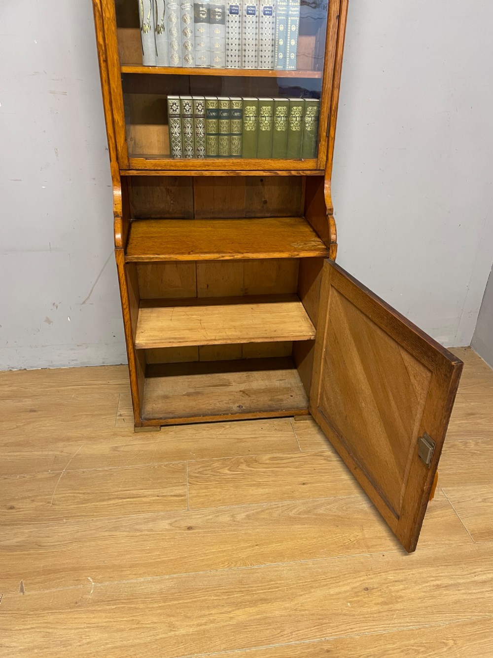Arts and Crafts golden oak slim bookcase over cupboard View VII